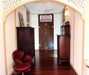 View of the main corridor, with entrance to the first bedroom on the left and entrance to the second bedroom on the right