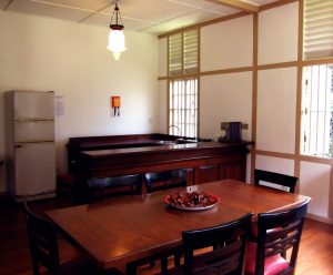 View of wooden dining table and kitchen counters