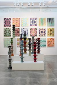 Installation view of M13 with Pilotis and Windows, dimensions variable, Melamine tableware, Puttyfilla, sand, cement and enamel paint and Oil and enamel on MDF board with powder-coated steel frames